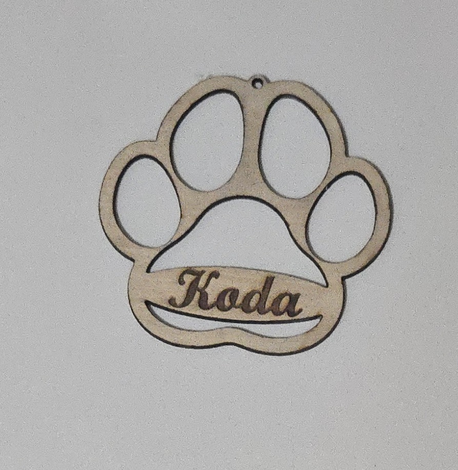 Personalized wooden paw print pet ornament, laser-cut with name 'Koda' by PetiteTrace