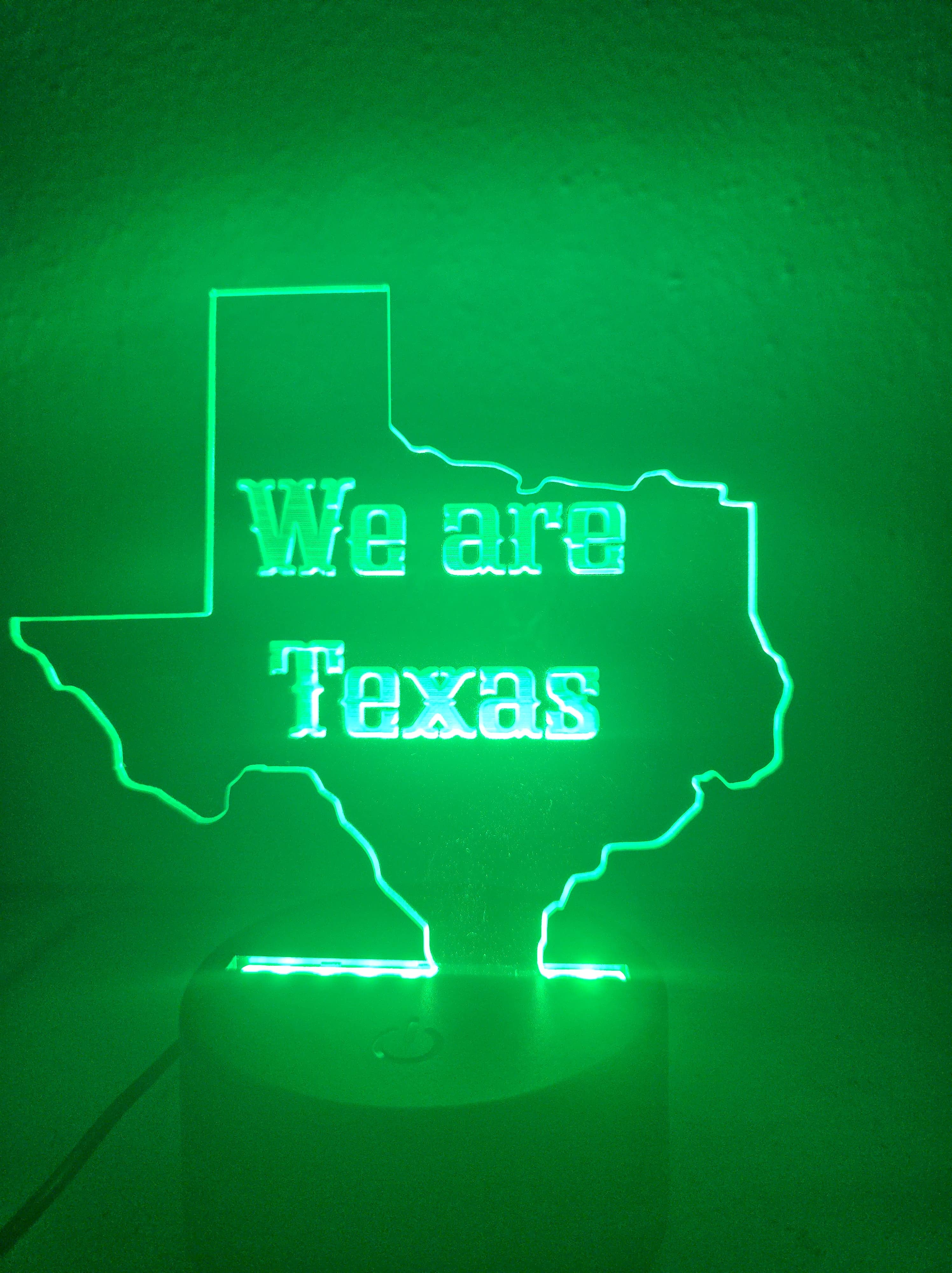 Custom 'We are Texas' LED acrylic night light sign, illuminated in green, by PetiteTrace